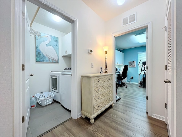 interior space featuring cabinets, independent washer and dryer, and light wood-type flooring