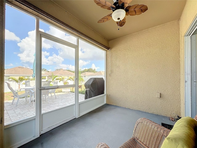 sunroom featuring ceiling fan