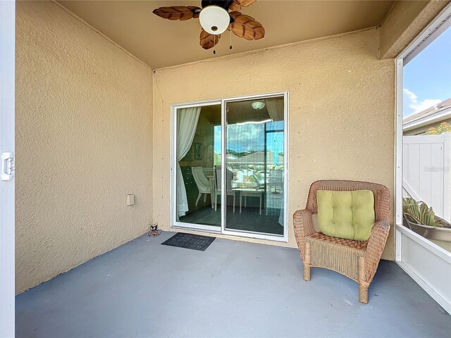 doorway to property featuring a patio area and ceiling fan