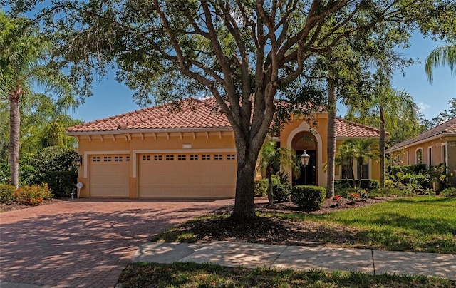 mediterranean / spanish-style home featuring a garage