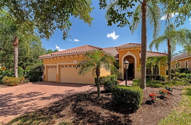 mediterranean / spanish-style home with a garage