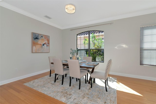 dining room featuring ornamental molding and hardwood / wood-style flooring