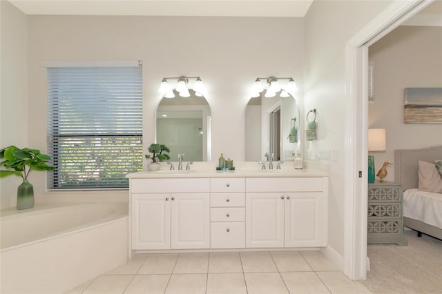 bathroom featuring tile patterned flooring, a bathtub, and vanity