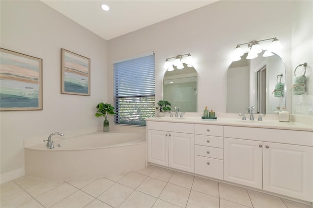 bathroom featuring tile patterned flooring, a bathtub, and vanity