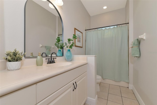 bathroom featuring tile patterned floors, vanity, and toilet