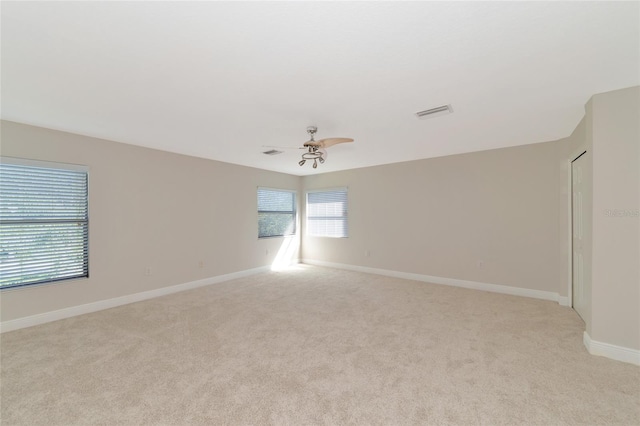 carpeted empty room featuring ceiling fan