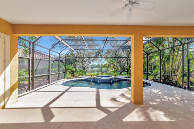 view of pool featuring an in ground hot tub, glass enclosure, ceiling fan, and a patio area