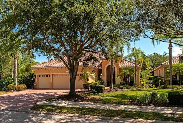 mediterranean / spanish home with a garage