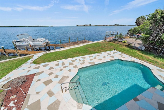 view of swimming pool with a boat dock, a water view, and a yard