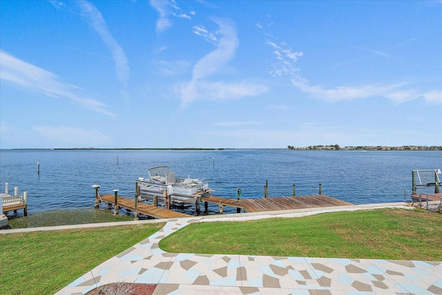 dock area with a water view and a lawn