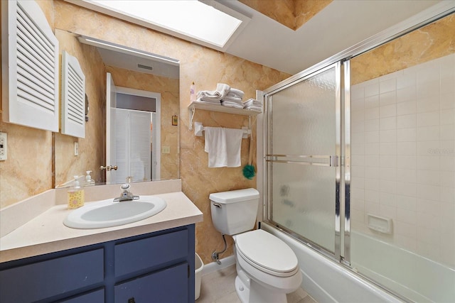 full bathroom featuring tile walls, enclosed tub / shower combo, tile floors, toilet, and vanity