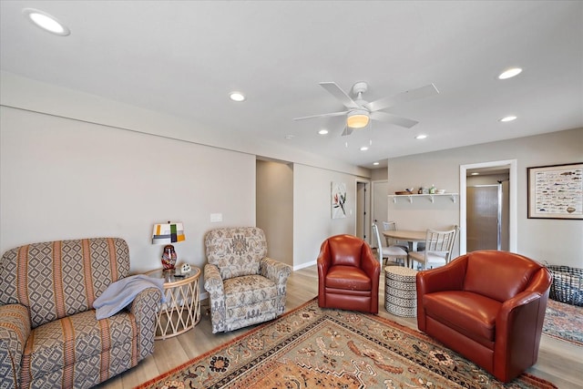 living room with ceiling fan and hardwood / wood-style floors