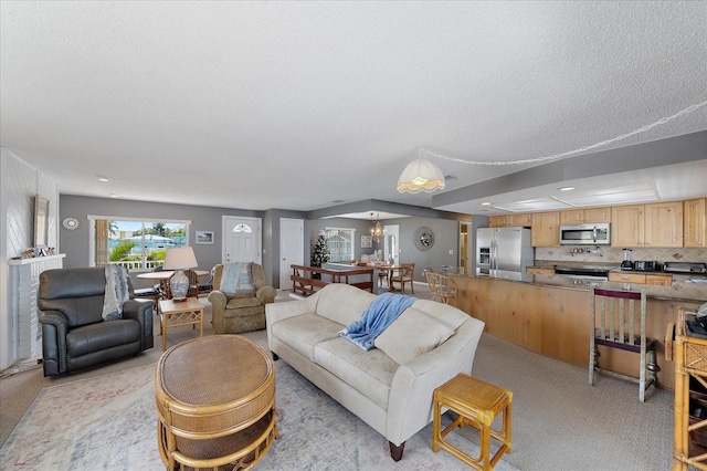 carpeted living room featuring a textured ceiling