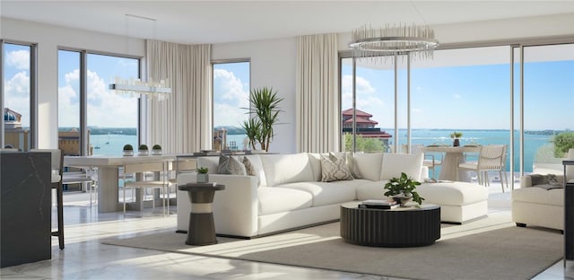 living room with a notable chandelier and a water view