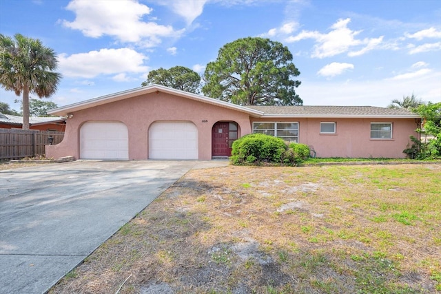 single story home with a garage and a front yard