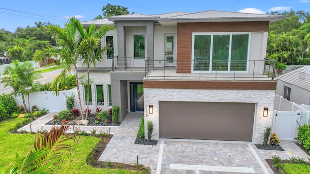 view of front of property featuring a garage and a balcony