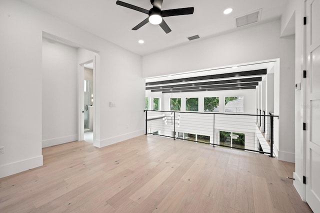 unfurnished living room with light hardwood / wood-style flooring and ceiling fan