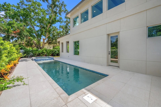 view of pool with an in ground hot tub and a patio