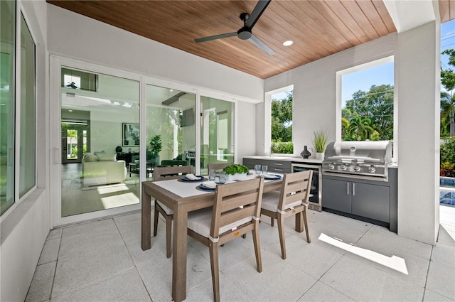 sunroom / solarium with ceiling fan and wooden ceiling