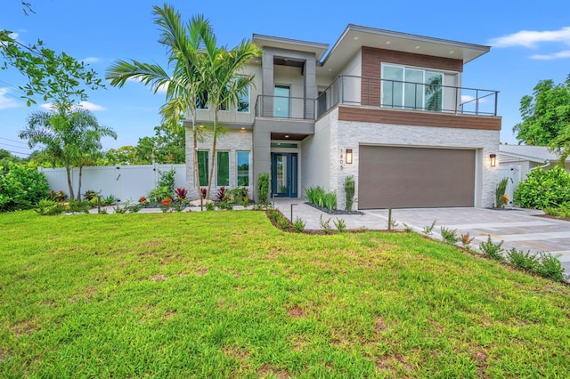 modern home featuring a balcony, a garage, and a front lawn