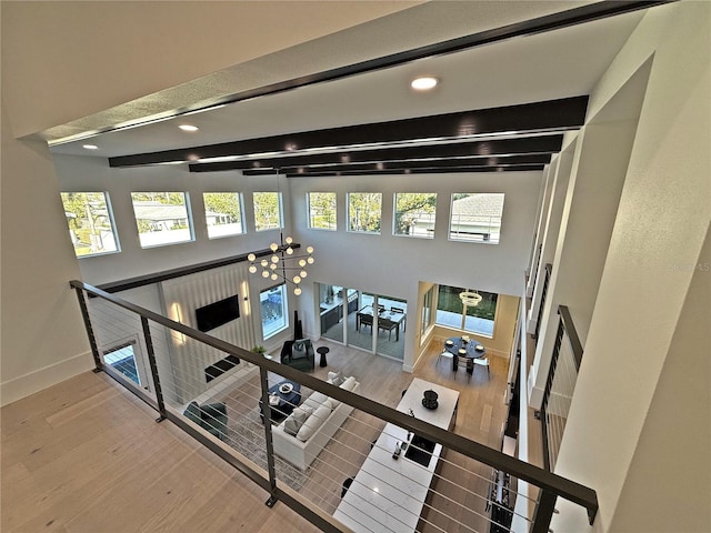 interior space with hardwood / wood-style flooring and beamed ceiling