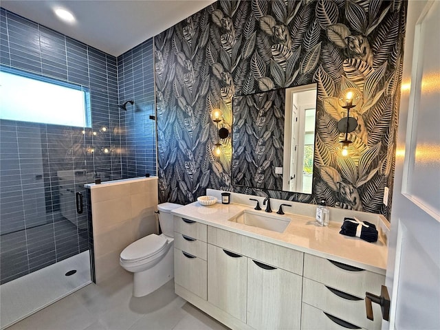 bathroom with tile patterned floors, a shower with door, vanity, and toilet