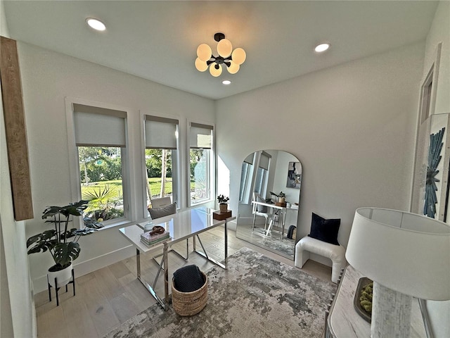 office area with a chandelier and light hardwood / wood-style flooring