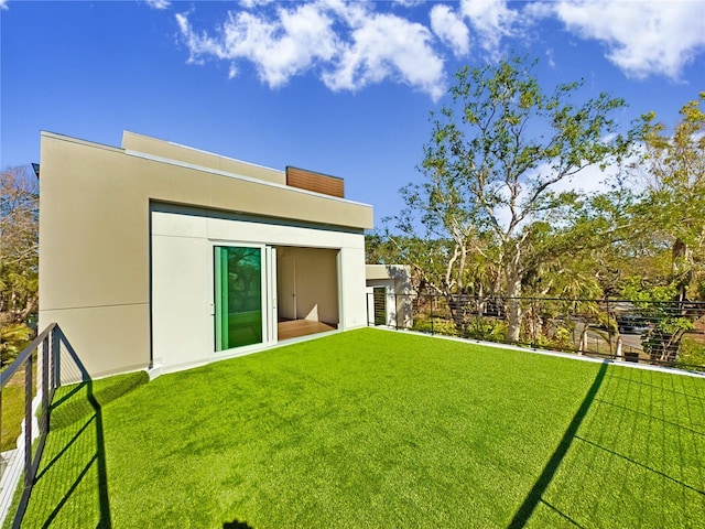 rear view of house with a lawn