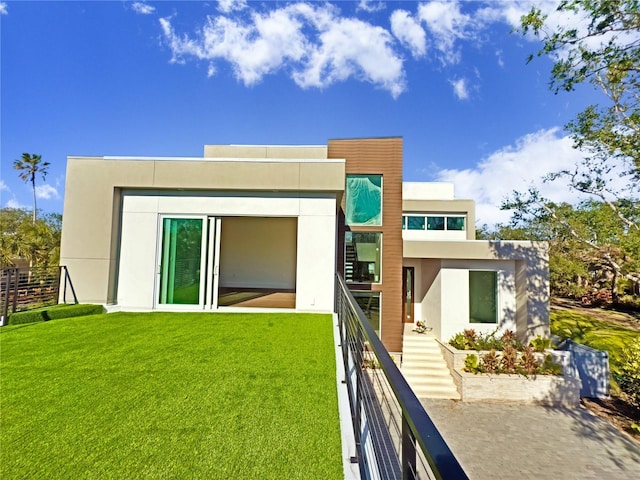 back of property featuring a yard and a balcony