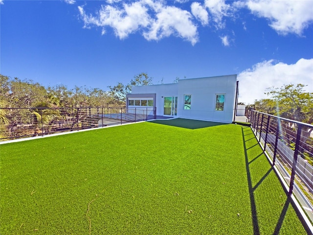 rear view of property featuring a yard