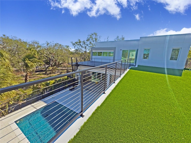 rear view of property featuring a lawn