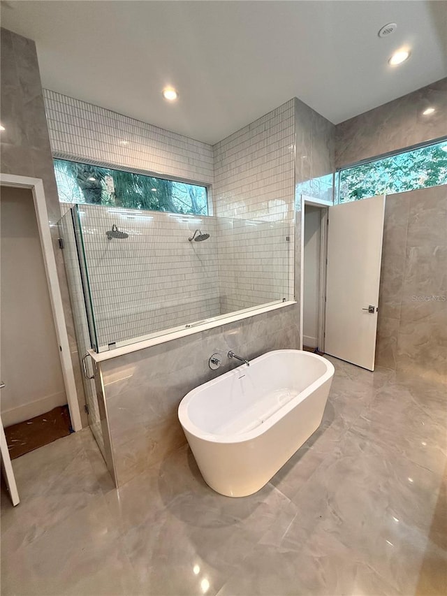 bathroom with plus walk in shower and tile walls