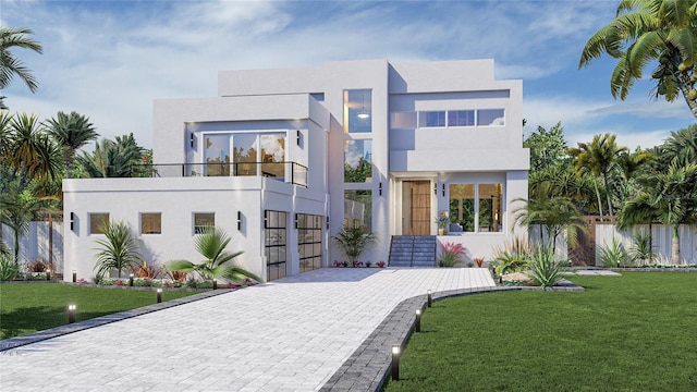 contemporary home featuring a balcony and a front lawn