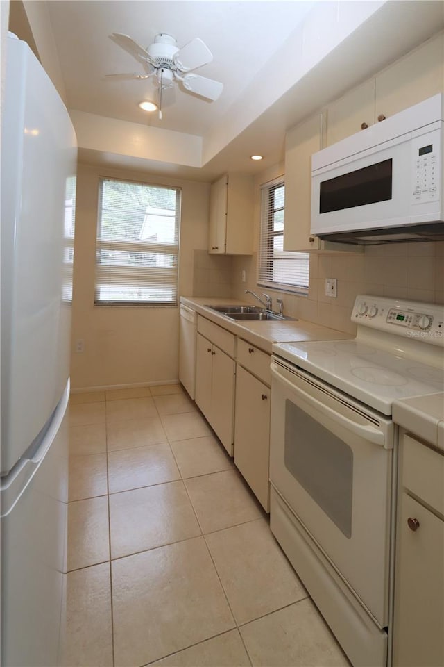 kitchen featuring decorative backsplash, white appliances, ceiling fan, sink, and light tile patterned floors