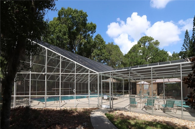 view of pool with a lanai and a patio