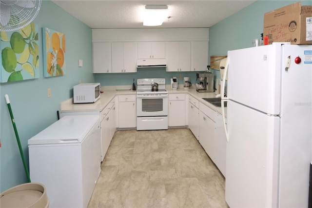 kitchen with a textured ceiling, range hood, white cabinets, and white appliances