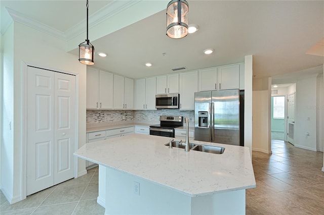 1020 Tidewater Shores Loop Unit 108, Bradenton, FL 34208 - kitchen with stainless steel appliances, light tile patterned floors, ornamental molding, decorative backsplash, and white cabinetry