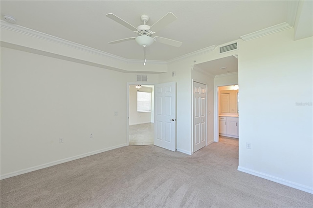 1020 Tidewater Shores Loop Unit 108, Bradenton, FL 34208 - unfurnished bedroom with light colored carpet, crown molding, ensuite bath, and ceiling fan