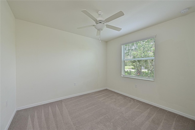 1020 Tidewater Shores Loop Unit 108, Bradenton, FL 34208 - empty room featuring light colored carpet, ceiling fan, and a smoke detector