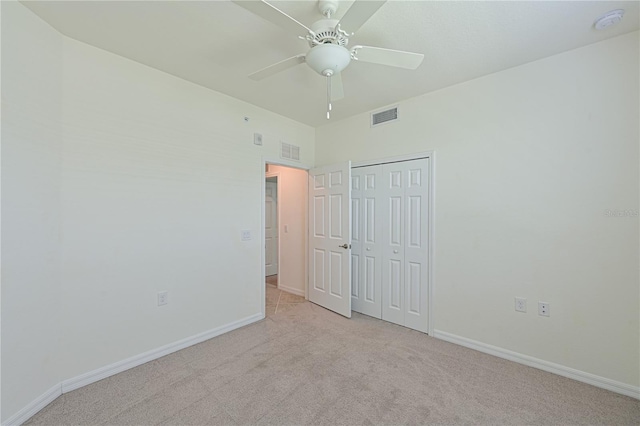 1020 Tidewater Shores Loop Unit 108, Bradenton, FL 34208 - unfurnished bedroom with light colored carpet, a closet, and a ceiling fan