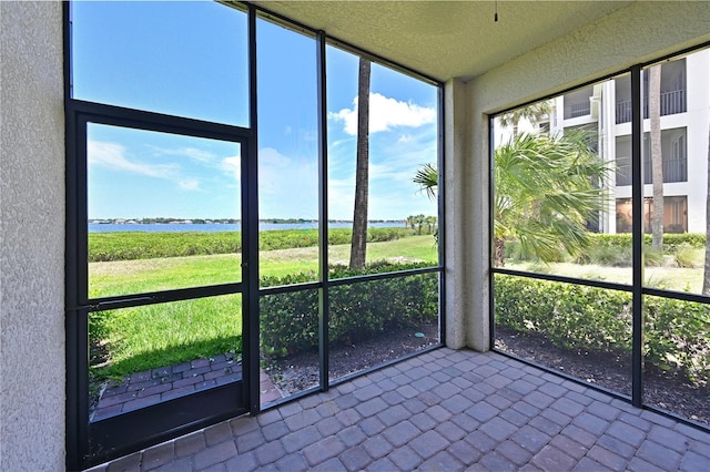1020 Tidewater Shores Loop Unit 108, Bradenton, FL 34208 - unfurnished sunroom featuring a water view and healthy amount of natural light