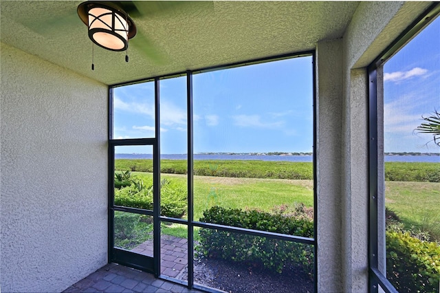 1020 Tidewater Shores Loop Unit 108, Bradenton, FL 34208 - unfurnished sunroom featuring a textured wall