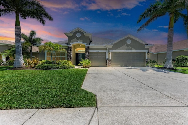 view of front of house featuring a lawn and a garage