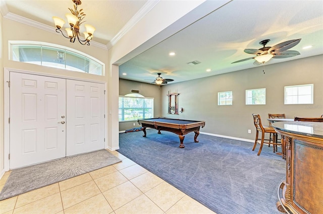 foyer entrance with light tile patterned flooring, ornamental molding, ceiling fan with notable chandelier, and billiards