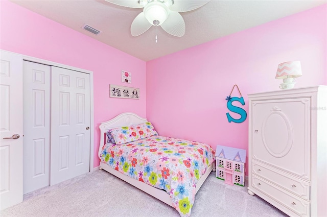 bedroom featuring ceiling fan, light colored carpet, and a closet