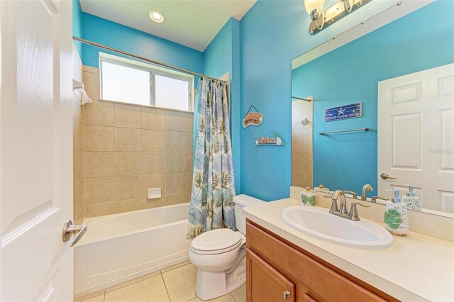 full bathroom featuring tile patterned floors, shower / tub combo with curtain, vanity, and toilet