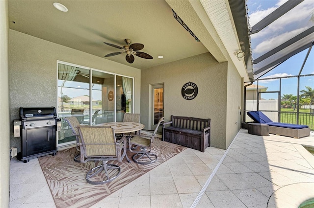 view of patio with ceiling fan, area for grilling, and a lanai