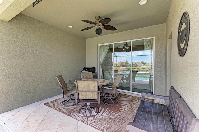 view of patio / terrace with ceiling fan and a water view