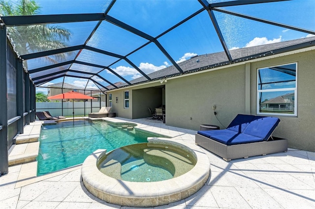 view of pool featuring an in ground hot tub, a patio, and glass enclosure