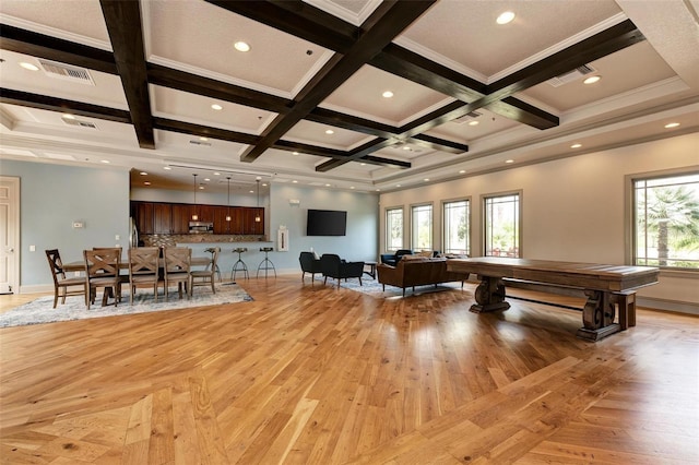 playroom with coffered ceiling, ornamental molding, beamed ceiling, and light hardwood / wood-style flooring